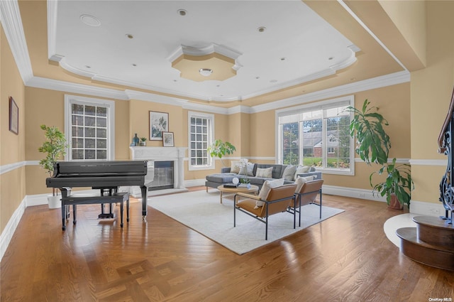 sitting room featuring a tray ceiling, crown molding, and hardwood / wood-style floors