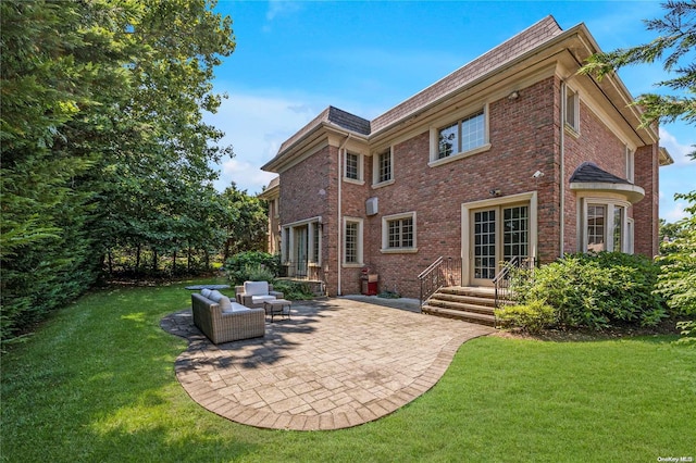 back of house featuring a lawn and a patio