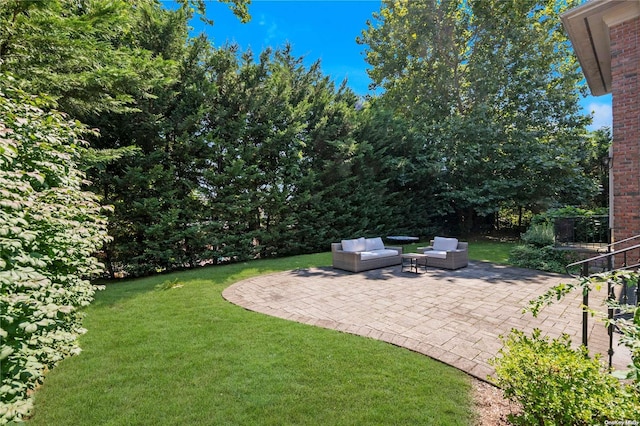 view of yard with an outdoor living space and a patio