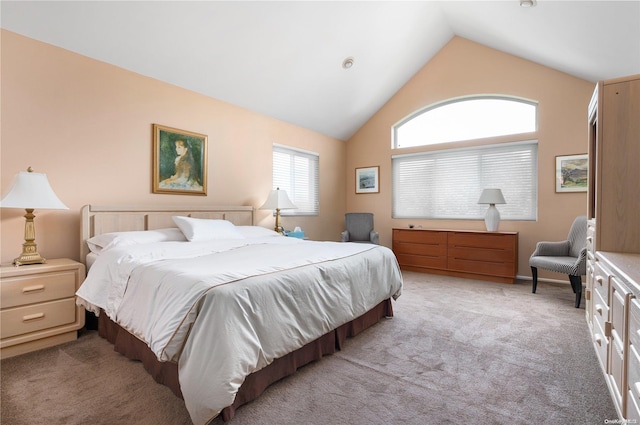 bedroom with light colored carpet and lofted ceiling