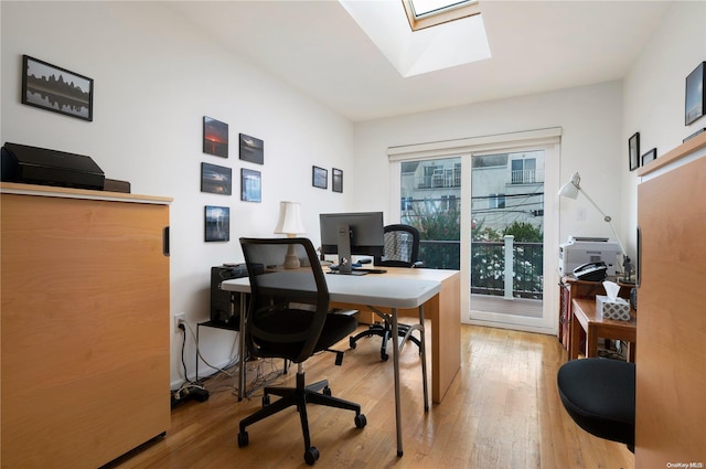 office area featuring wood-type flooring and a skylight