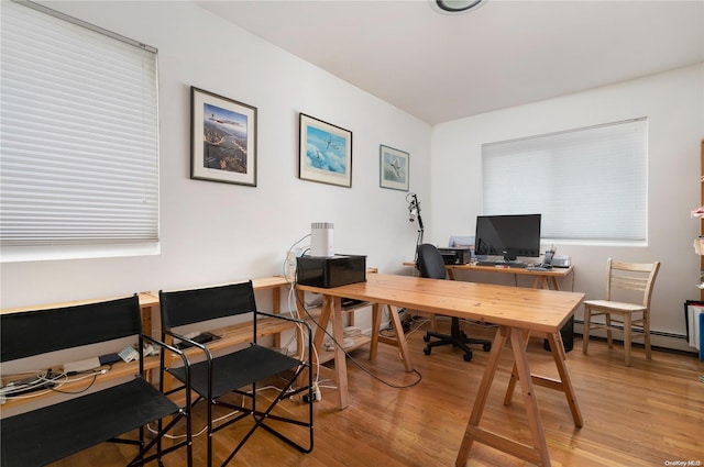 office with a baseboard radiator and hardwood / wood-style flooring