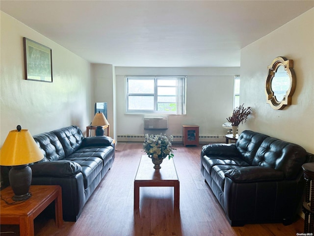 living room featuring wood-type flooring, a baseboard radiator, and a wall unit AC