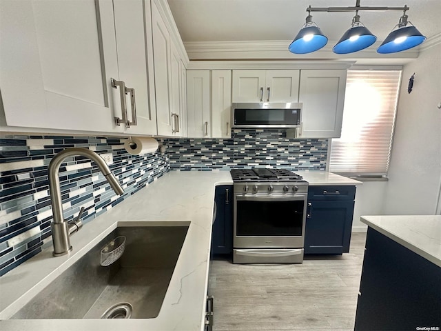 61-20 Grand Central Pkwy Unit B401, Forest Hills, NY 11375 - kitchen with appliances with stainless steel finishes, backsplash, sink, white cabinetry, and hanging light fixtures