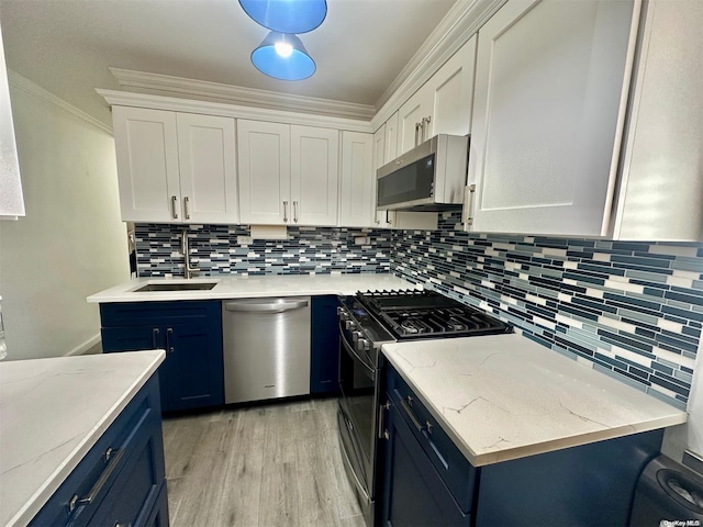 61-20 Grand Central Pkwy Unit B401, Forest Hills, NY 11375 - kitchen featuring white cabinets, blue cabinets, sink, decorative backsplash, and stainless steel appliances