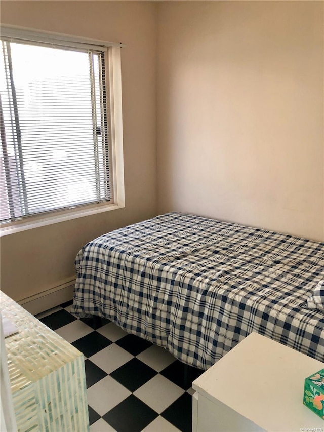 bedroom with a baseboard heating unit