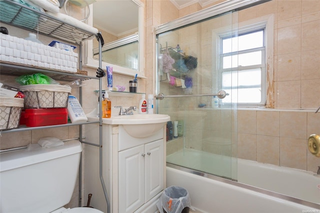 full bathroom featuring vanity, toilet, crown molding, and enclosed tub / shower combo