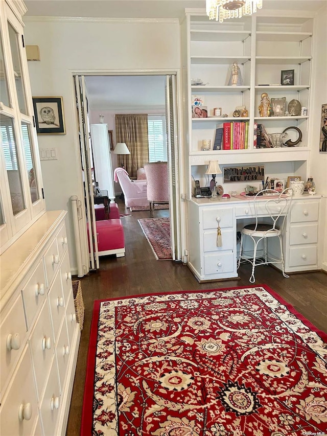 office with radiator heating unit, built in desk, dark wood-type flooring, and ornamental molding