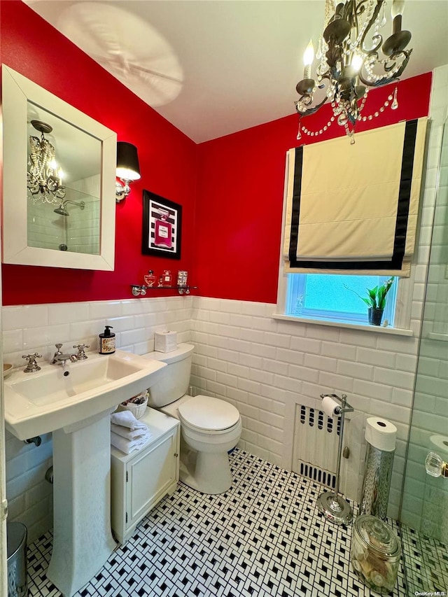 bathroom with tile patterned floors, toilet, tile walls, and radiator