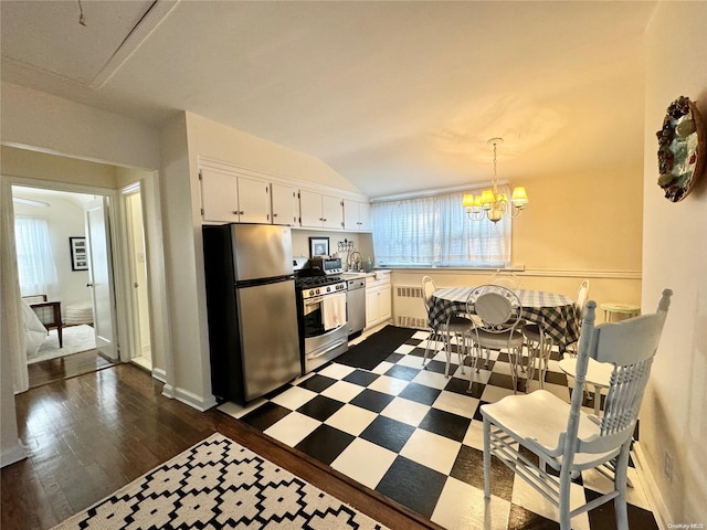 kitchen featuring dark wood-type flooring, white cabinets, a healthy amount of sunlight, and appliances with stainless steel finishes