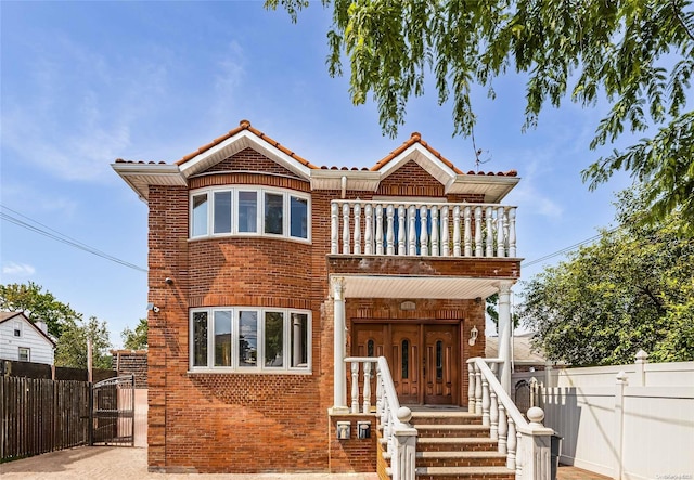 view of front of property with covered porch and a balcony