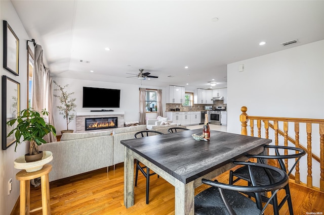 dining space with ceiling fan and light hardwood / wood-style floors