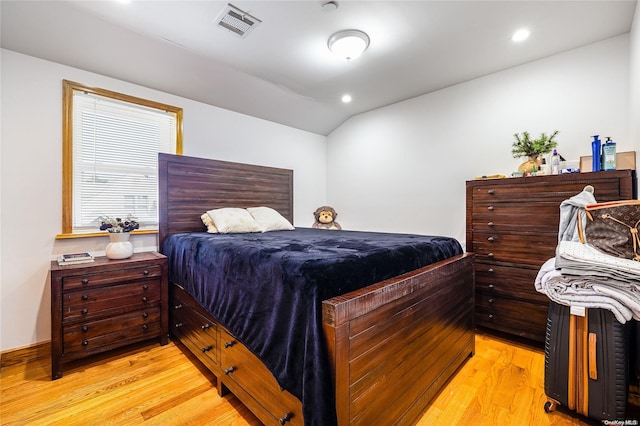 bedroom featuring lofted ceiling and light hardwood / wood-style flooring