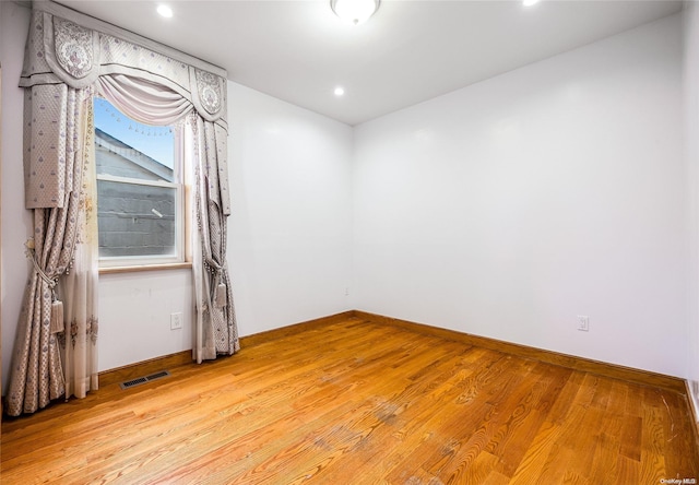 unfurnished room with light wood-type flooring