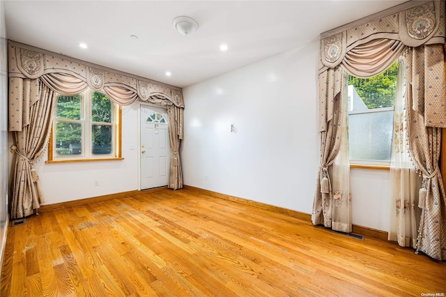 unfurnished room with hardwood / wood-style floors