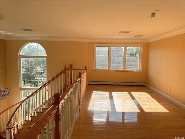 interior space with plenty of natural light, light hardwood / wood-style floors, and baseboard heating