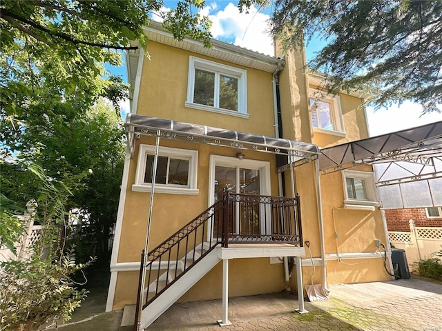 rear view of property featuring central air condition unit