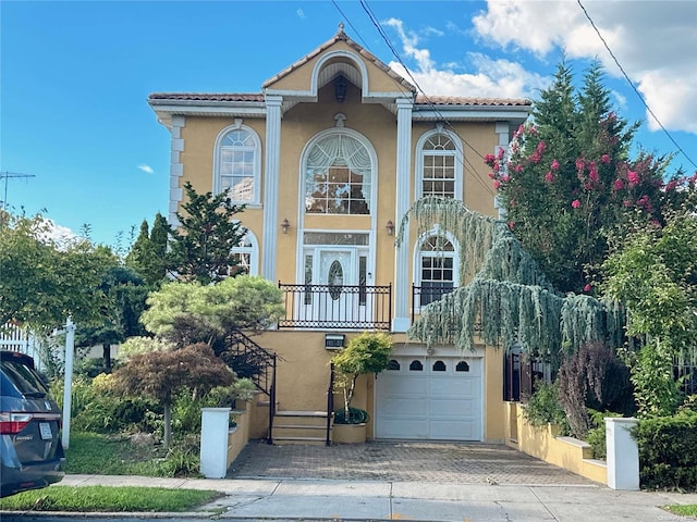 mediterranean / spanish-style house with a garage