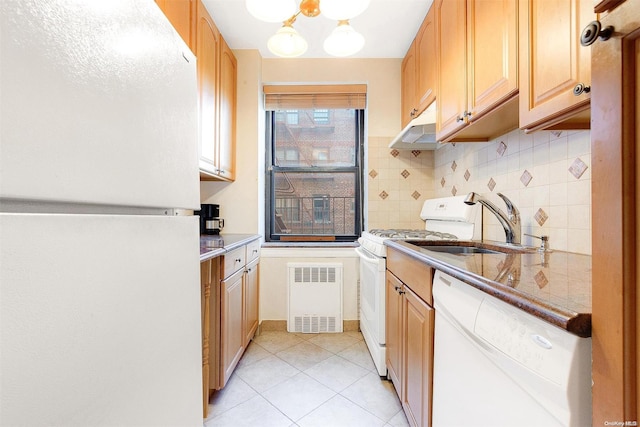 kitchen with white appliances, sink, light tile patterned floors, light brown cabinetry, and tasteful backsplash