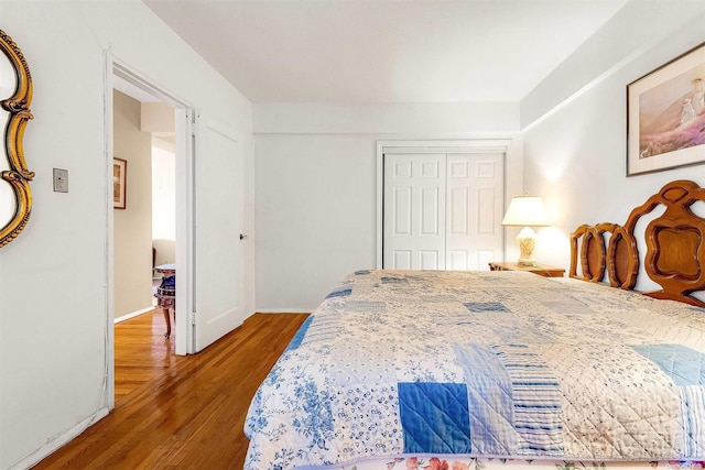 bedroom featuring hardwood / wood-style floors and a closet