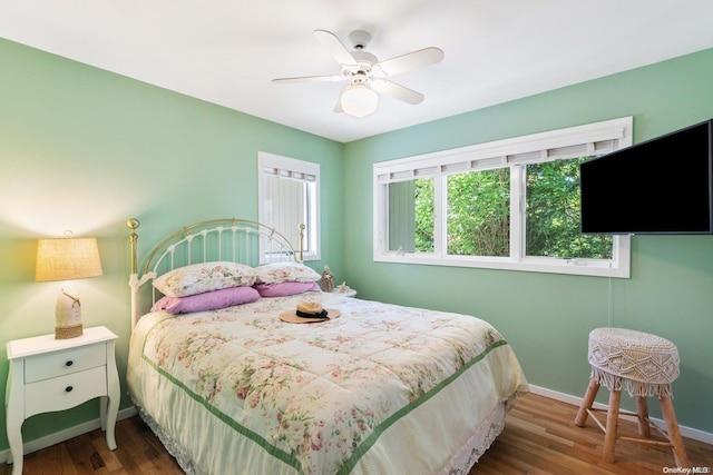 bedroom with ceiling fan and dark wood-type flooring