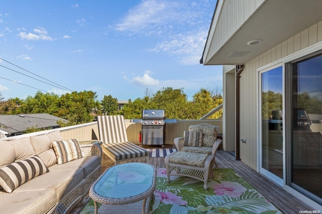 wooden deck with grilling area and an outdoor hangout area