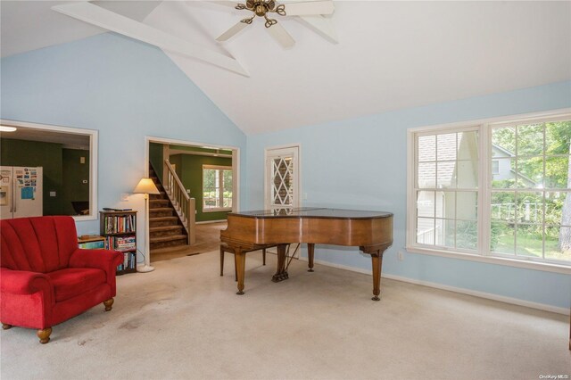 sitting room with carpet flooring, stairway, high vaulted ceiling, baseboards, and ceiling fan