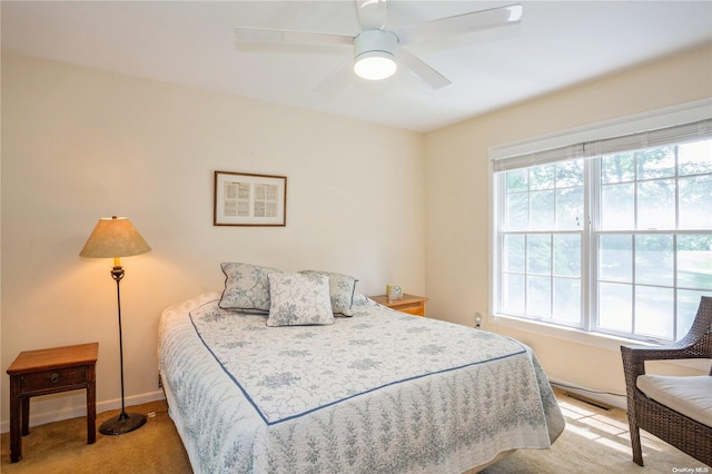 bedroom with light carpet, baseboards, and ceiling fan