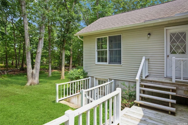 wooden deck featuring a lawn