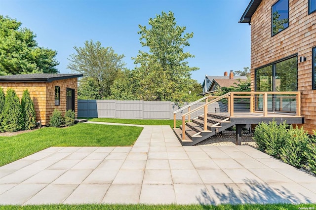 216 N St, Greenport, NY 11944 - view of patio featuring a wooden deck and an outdoor structure