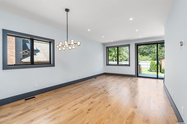 216 N St, Greenport, NY 11944 - empty room with wood finished floors, recessed lighting, and a chandelier