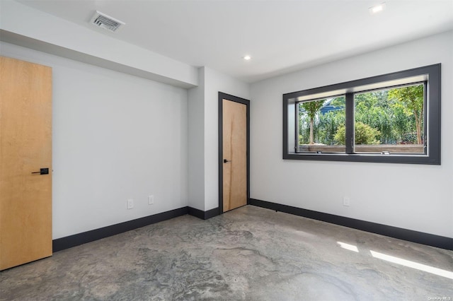 216 N St, Greenport, NY 11944 - unfurnished bedroom featuring concrete flooring and recessed lighting