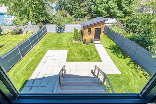 216 N St, Greenport, NY 11944 - fenced backyard with a patio area and an outdoor structure