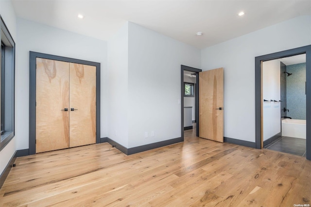216 N St, Greenport, NY 11944 - unfurnished bedroom with light wood-type flooring and recessed lighting