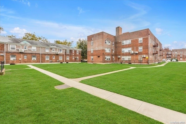 view of home's community featuring a lawn