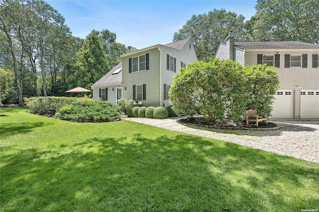 view of front of home with a garage and a front yard