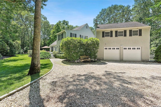 view of front of property featuring a garage and a front lawn