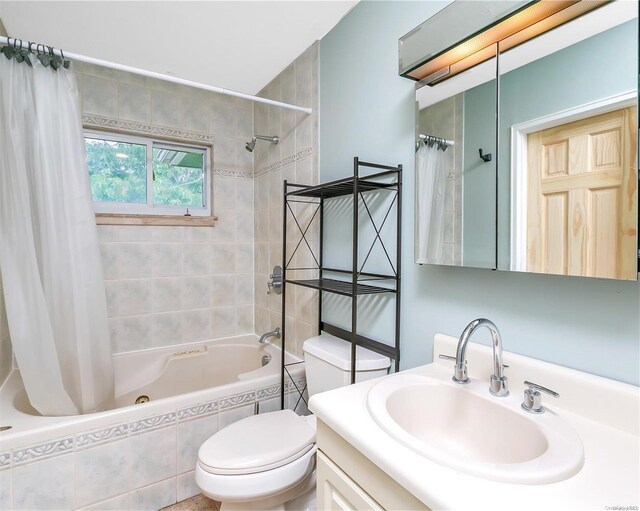 full bathroom with shower / bath combination with curtain, vanity, and toilet