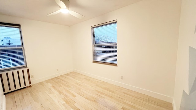 unfurnished room featuring ceiling fan, plenty of natural light, and light wood-type flooring