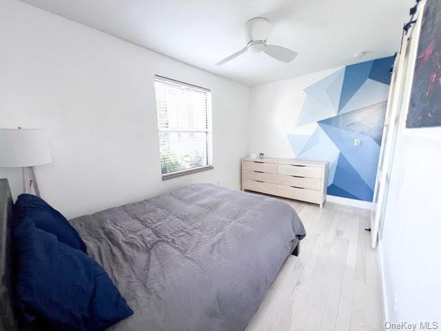 bedroom featuring light wood-type flooring and ceiling fan