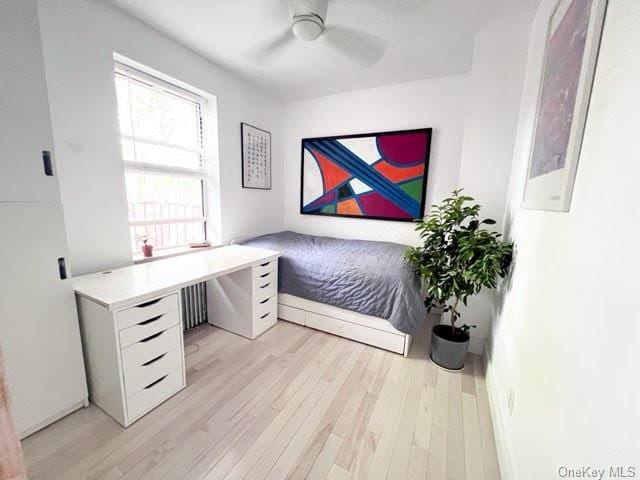 bedroom with ceiling fan and light hardwood / wood-style flooring