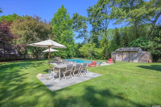 view of yard with a patio and a storage unit