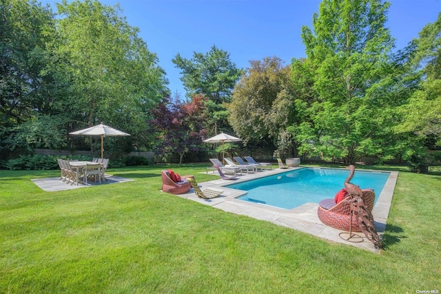 view of pool with a patio area and a yard