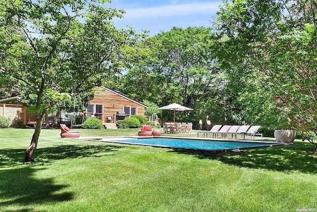 view of pool with a yard