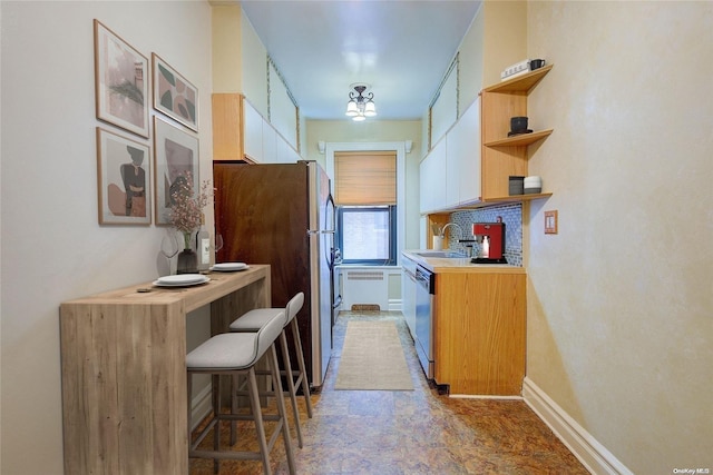 kitchen with decorative backsplash, stainless steel appliances, and sink