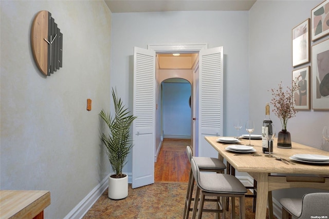 dining space with hardwood / wood-style floors