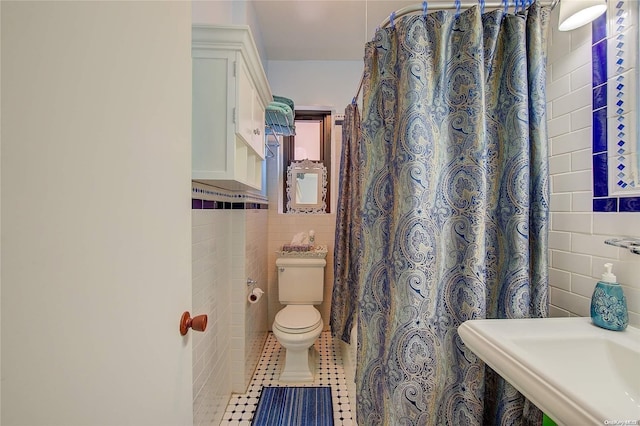 76-66 Austin St Unit 2-O, Forest Hills, NY 11375 - bathroom featuring tile walls, toilet, tile patterned flooring, a wainscoted wall, and a shower with curtain