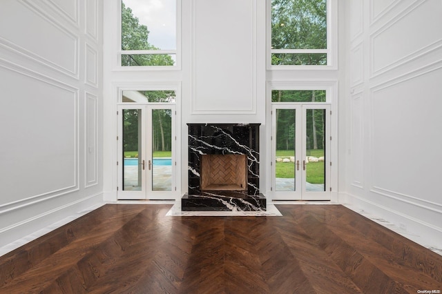 interior space with french doors, dark parquet floors, and plenty of natural light