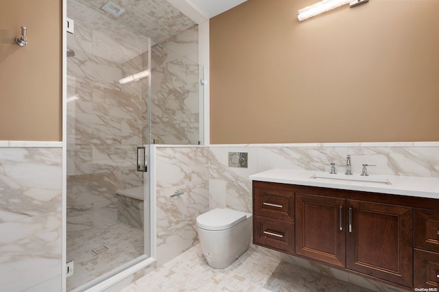 bathroom featuring vanity, toilet, a shower with shower door, and tile walls