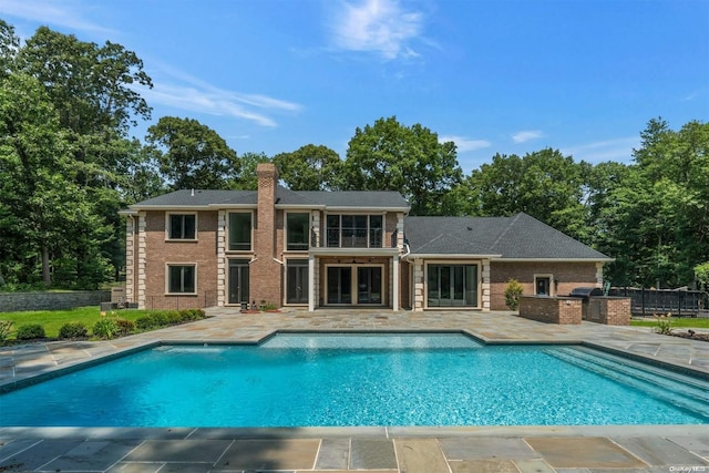 view of swimming pool featuring area for grilling and a patio area